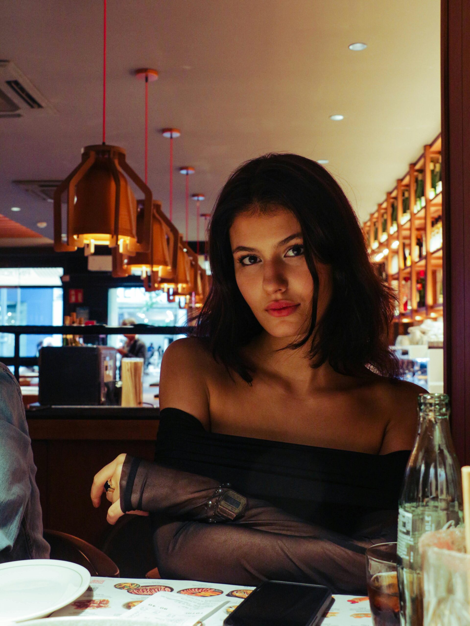Elegant woman enjoying dinner in a trendy Madrid restaurant.